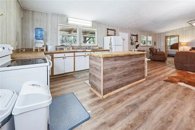 a kitchen with a stove a sink and a refrigerator