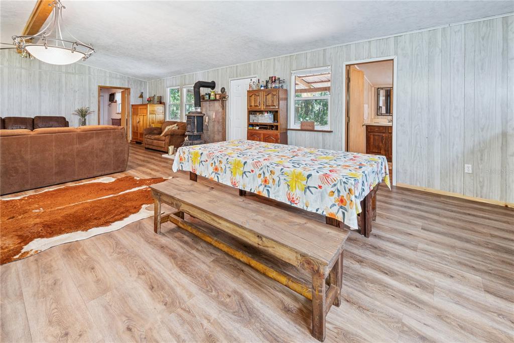 6550 Southwest 100 Court Cedar Key, FL 32625 - Photo 19 of 41 a bedroom with a bed and wooden floor