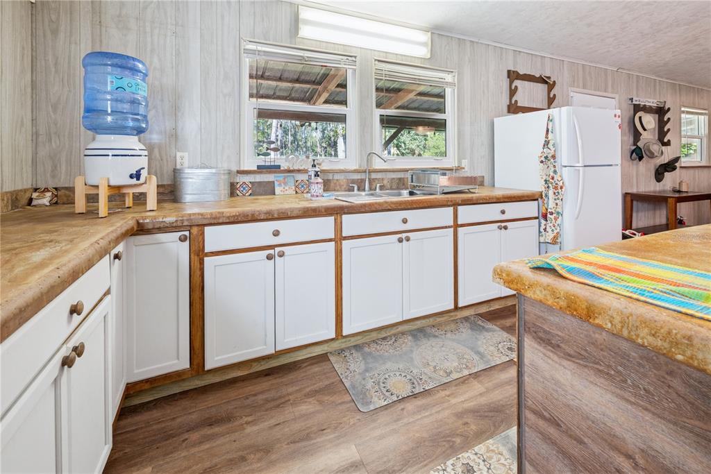 6550 Southwest 100 Court Cedar Key, FL 32625 - Photo 20 of 41 a kitchen with stainless steel appliances granite countertop a sink and a refrigerator