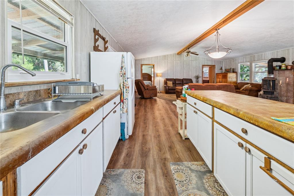 6550 Southwest 100 Court Cedar Key, FL 32625 - Photo 22 of 41 a view of a kitchen with a sink and wooden floor