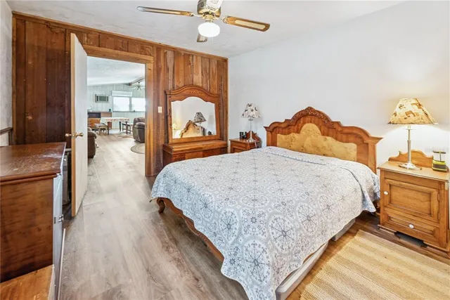 a bed sitting in a bedroom and chandelier