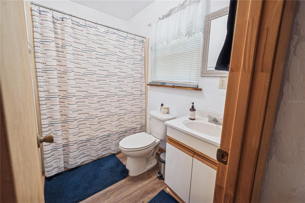 6550 Southwest 100 Court Cedar Key, FL 32625 - Photo 29 of 41 a bathroom with a sink a toilet and a mirror