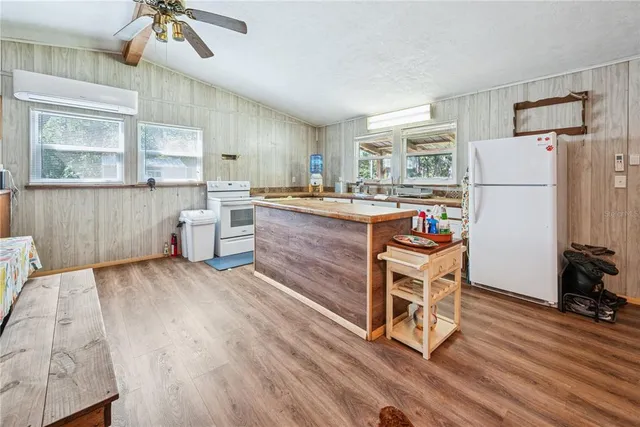 a spacious bathroom with a sink a mirror a toilet and a window