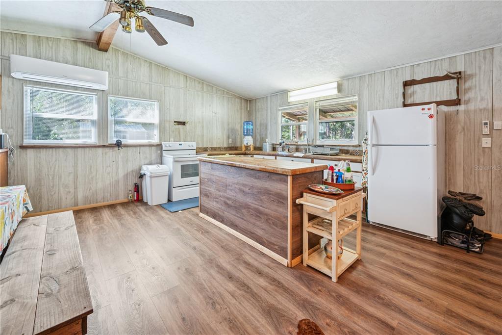 6550 Southwest 100 Court Cedar Key, FL 32625 - Photo 34 of 41 a living room with stainless steel appliances kitchen island hardwood floor and a large window