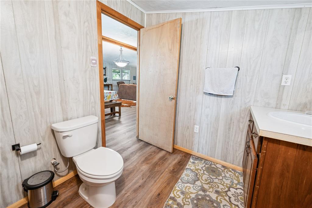 6550 Southwest 100 Court Cedar Key, FL 32625 - Photo 36 of 41 a bathroom with a sink a toilet and shower curtain
