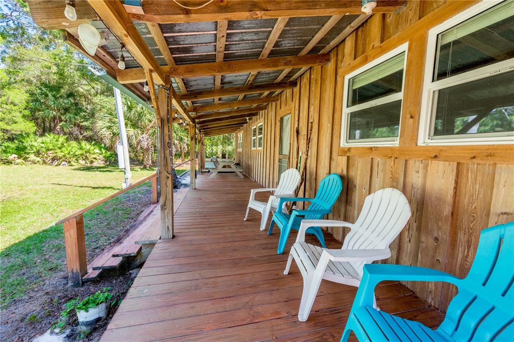 6550 Southwest 100 Court Cedar Key, FL 32625 - Photo 4 of 41 a view of a chairs in patio with wooden floor