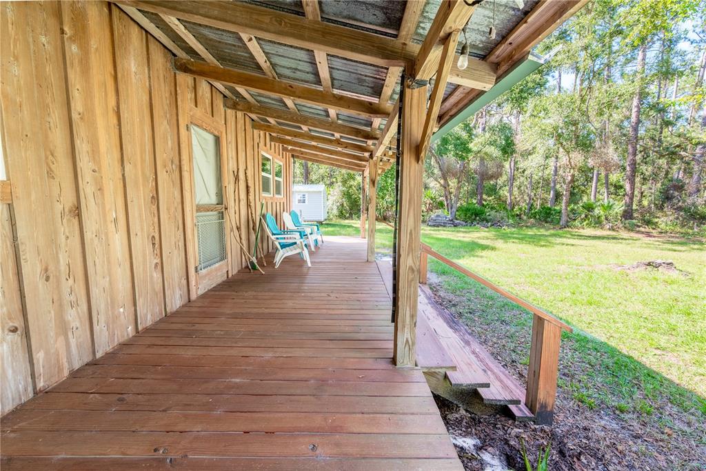 6550 Southwest 100 Court Cedar Key, FL 32625 - Photo 5 of 41 a view of a porch with wooden floor and outdoor space