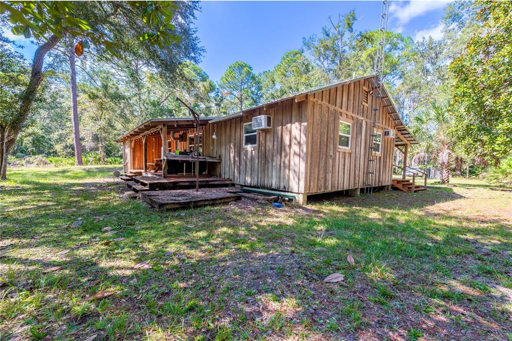 6550 Southwest 100 Court Cedar Key, FL 32625 - Photo 9 of 41 a view of a house with backyard