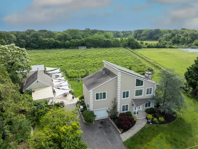 a view of a house with yard and a garden