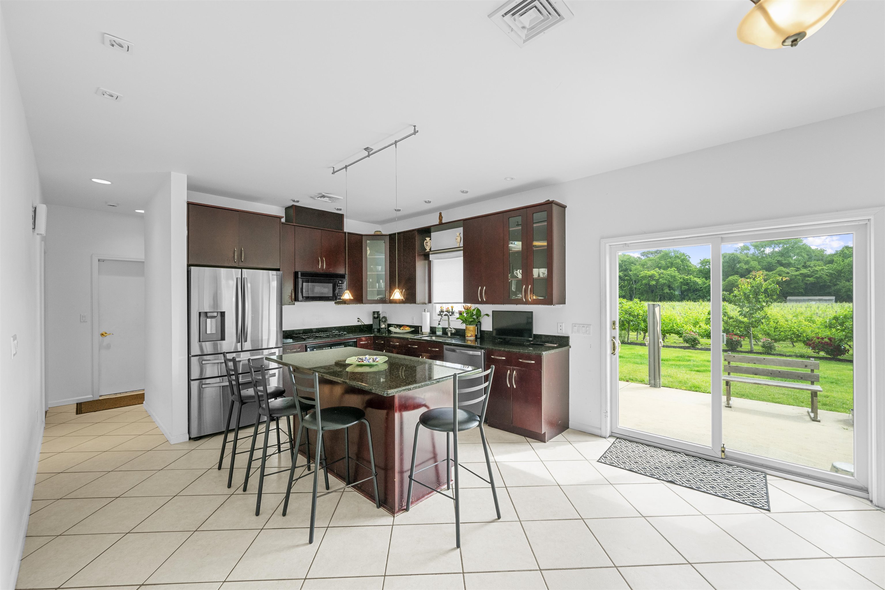 3911 Bayshore Road North Cape May, NJ 08204 - Photo 17 of 44 a kitchen with stainless steel appliances kitchen island granite countertop a refrigerator and a stove top oven
