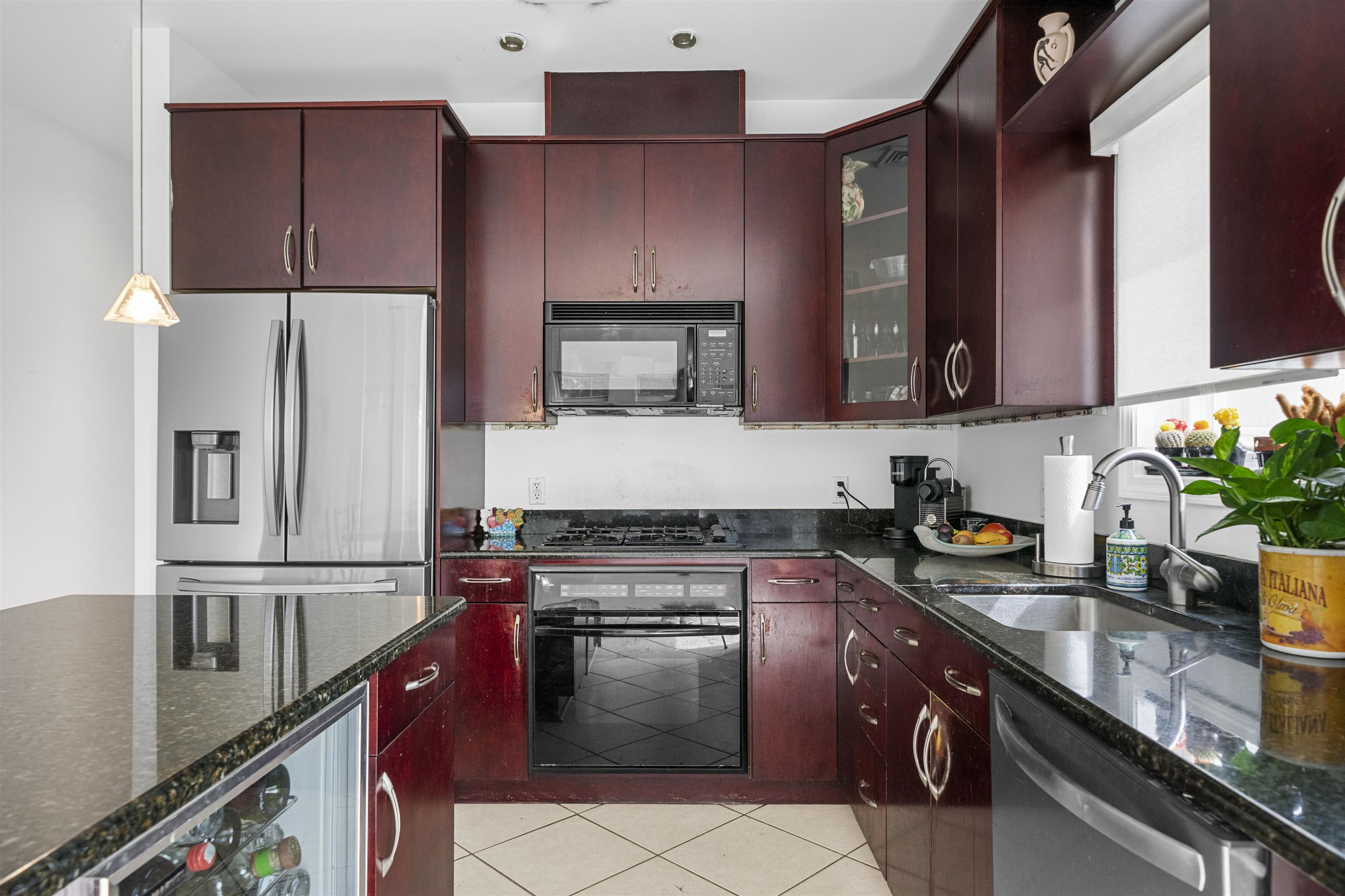 3911 Bayshore Road North Cape May, NJ 08204 - Photo 18 of 44 a kitchen with stainless steel appliances granite countertop a stove a sink dishwasher and a refrigerator