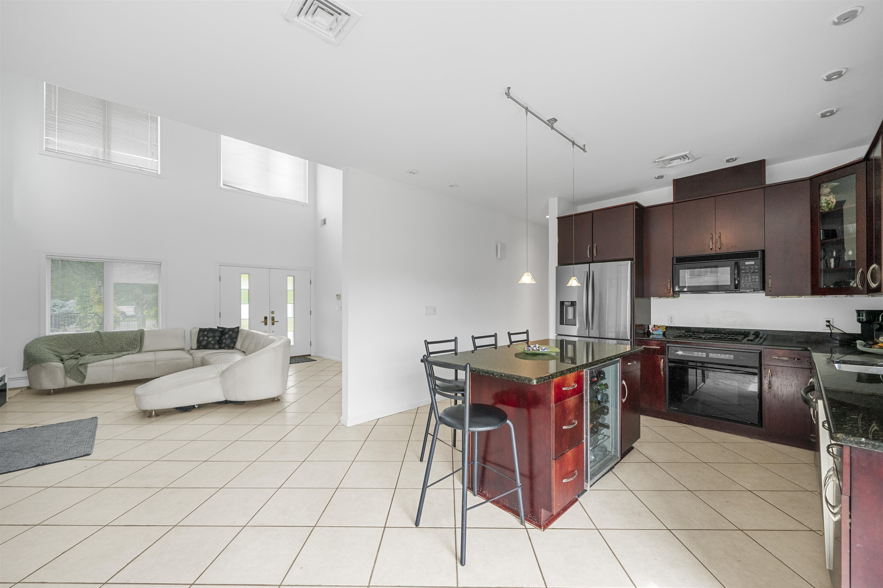 3911 Bayshore Road North Cape May, NJ 08204 - Photo 19 of 44 a kitchen with stainless steel appliances kitchen island granite countertop a table chairs and a refrigerator