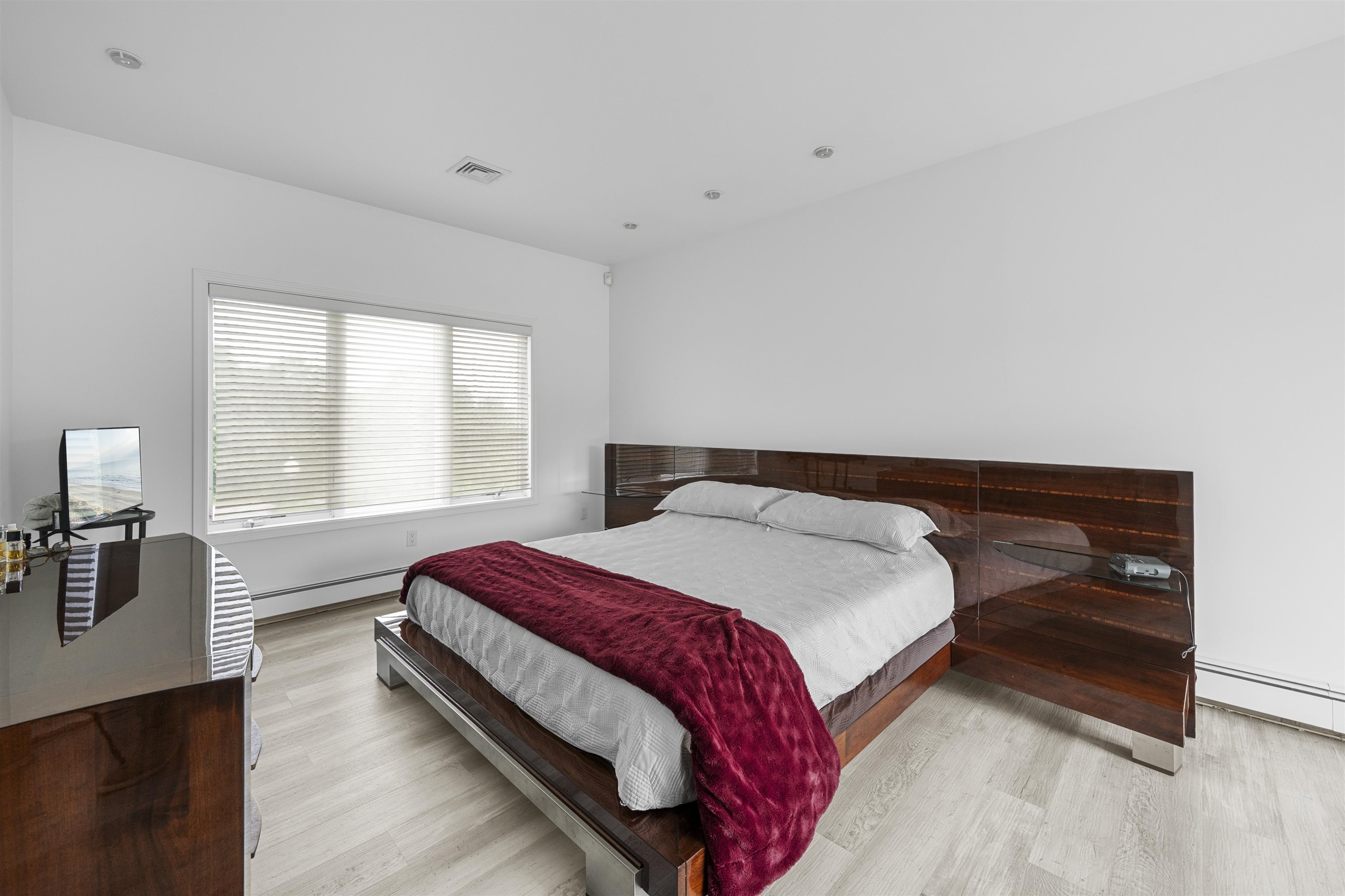 3911 Bayshore Road North Cape May, NJ 08204 - Photo 24 of 44 a bedroom with a bed and wooden floor