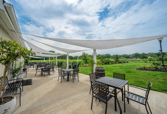 a outdoor space with lots of tables a garden view and chairs