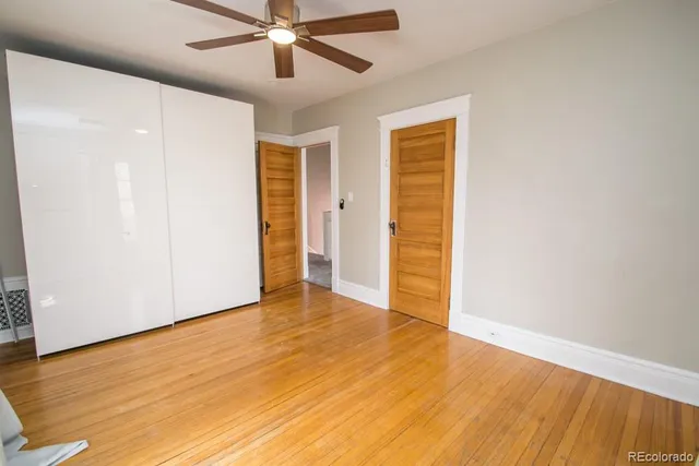 a view of an empty room with wooden floor