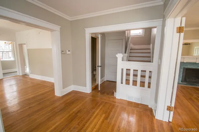 a view of a livingroom with wooden floor and windows