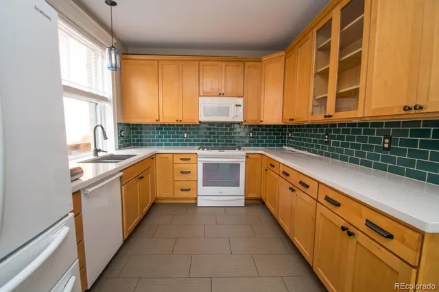 a kitchen with stainless steel appliances kitchen island granite countertop a sink and a stove