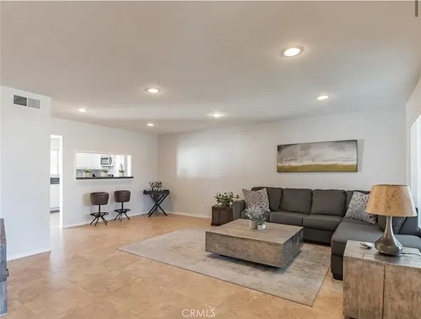a living room with furniture and a lamp with wooden floor