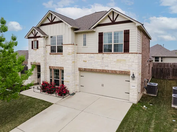 a front view of a house with a yard