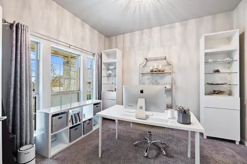 a view of a dining room with furniture and chandelier