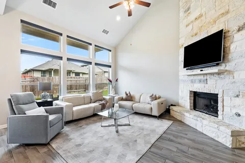 a living room with furniture fireplace and flat screen tv