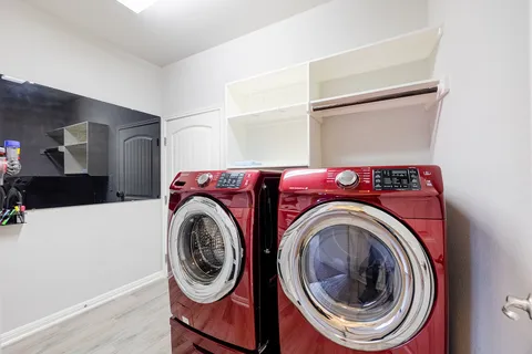 a bedroom with a bed and a lamp on dresser