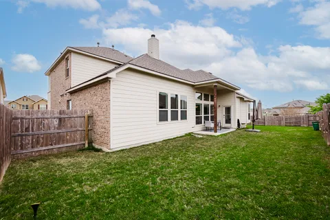a view of a house with backyard sitting area and garden