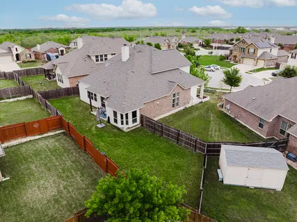 an aerial view of a house with a garden and lake view