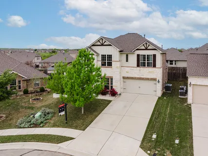 an aerial view of a house with a garden and a swimming pool