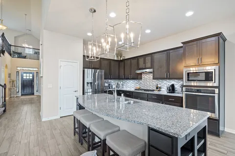 a kitchen with granite countertop center island and stainless steel appliances