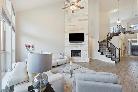 a living room with furniture a fireplace and a flat screen tv
