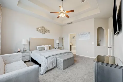 a bedroom with a bed and a large window