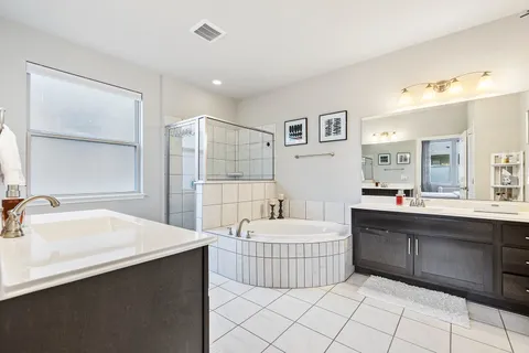 a bedroom with a large bed couch and a window