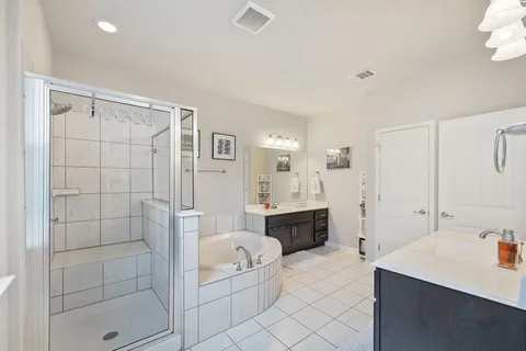 a bathroom with a tub sink and mirror