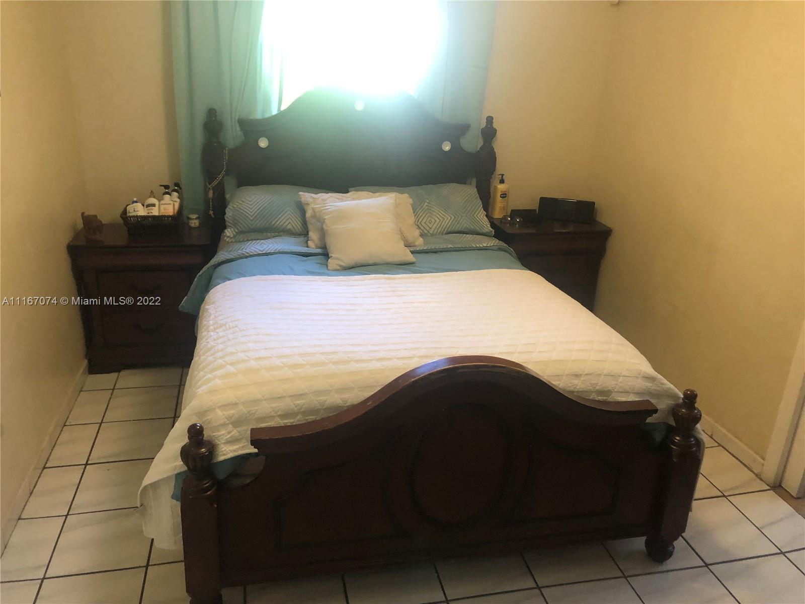 172 West 17th Street Hialeah, FL 33010 - Photo 12 of 27 a bedroom with a bed and a mirror