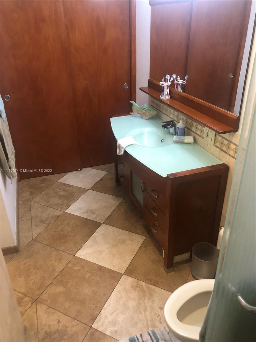 172 West 17th Street Hialeah, FL 33010 - Photo 15 of 27 a bathroom with a sink vanity mirror and toilet
