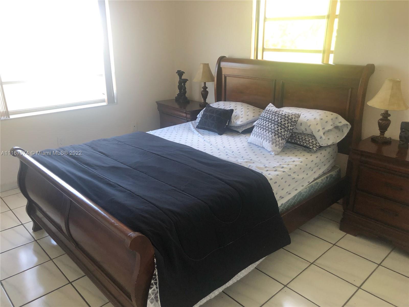 172 West 17th Street Hialeah, FL 33010 - Photo 16 of 27 a bedroom with a bed and window