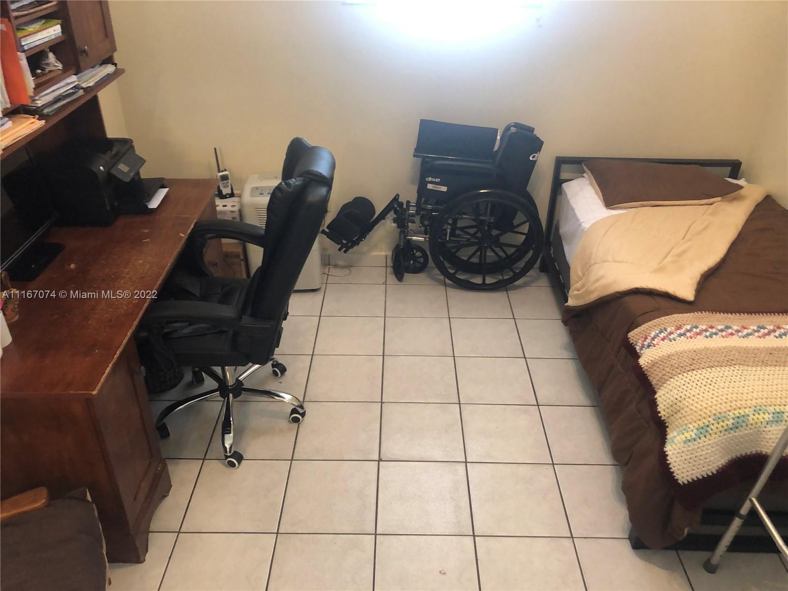 172 West 17th Street Hialeah, FL 33010 - Photo 18 of 27 a bed room with a bed and a chair