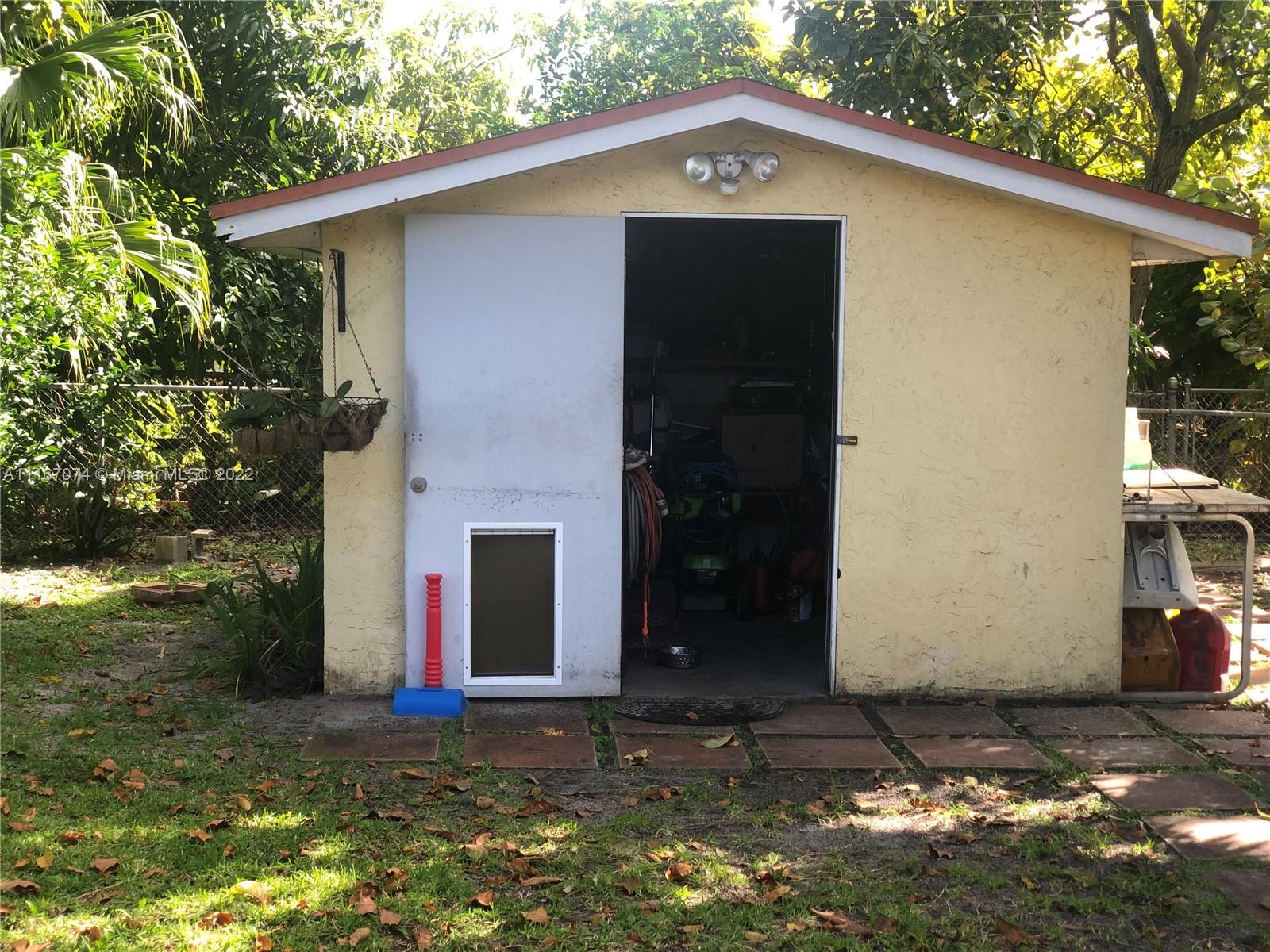 172 West 17th Street Hialeah, FL 33010 - Photo 24 of 27 a front view of a house with a yard and garage