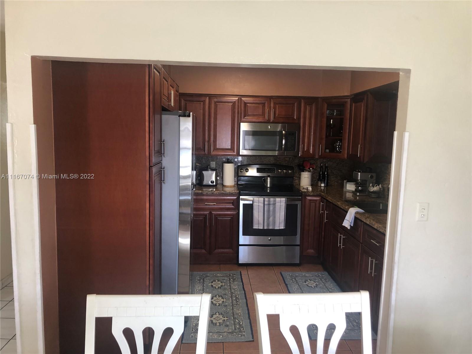 172 West 17th Street Hialeah, FL 33010 - Photo 8 of 27 a kitchen with a refrigerator and a stove