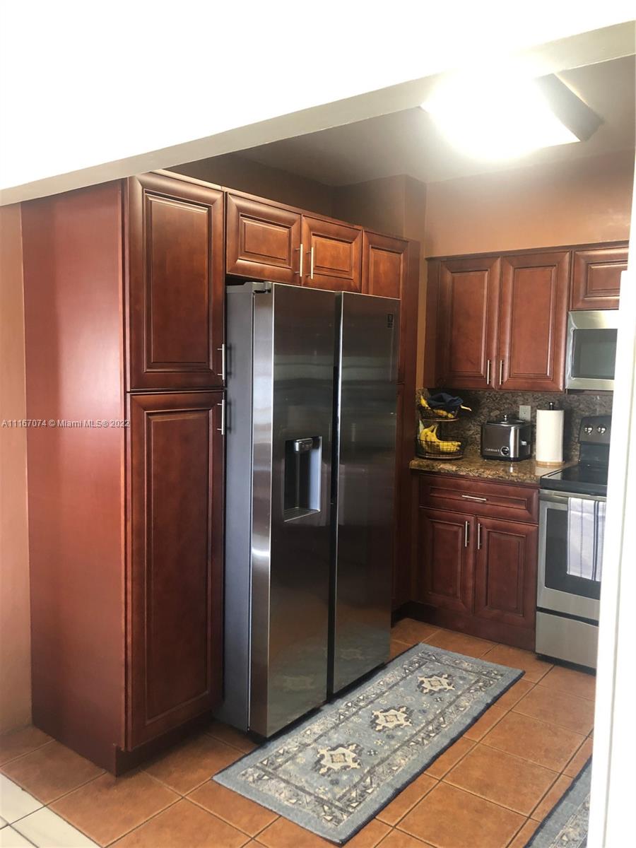 172 West 17th Street Hialeah, FL 33010 - Photo 10 of 27 a kitchen with stainless steel appliances granite countertop a refrigerator and a sink