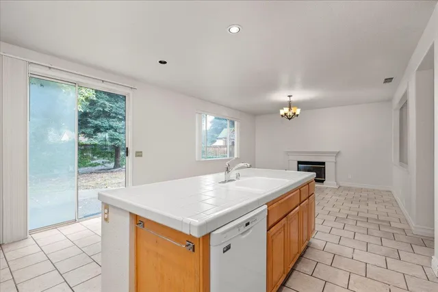 a kitchen with a sink a counter top space and appliances