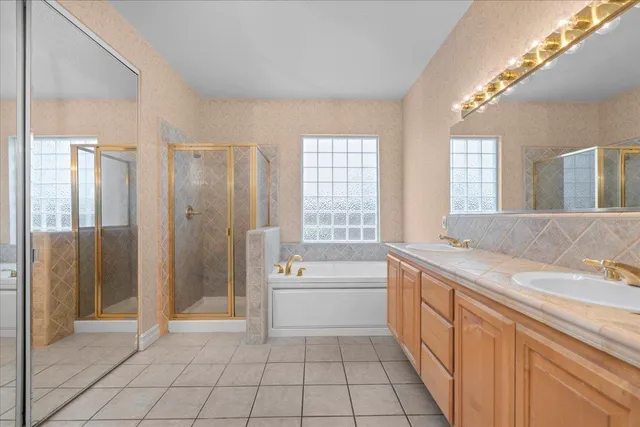 a spacious bathroom with a granite countertop sink a toilet and shower