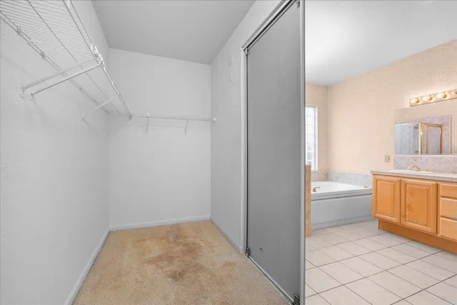 a bathroom with a granite countertop sink a toilet and a bathtub