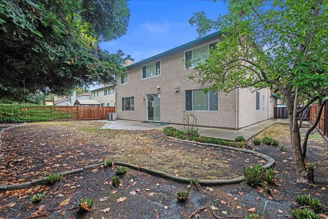 an aerial view of a house with a garden and swing
