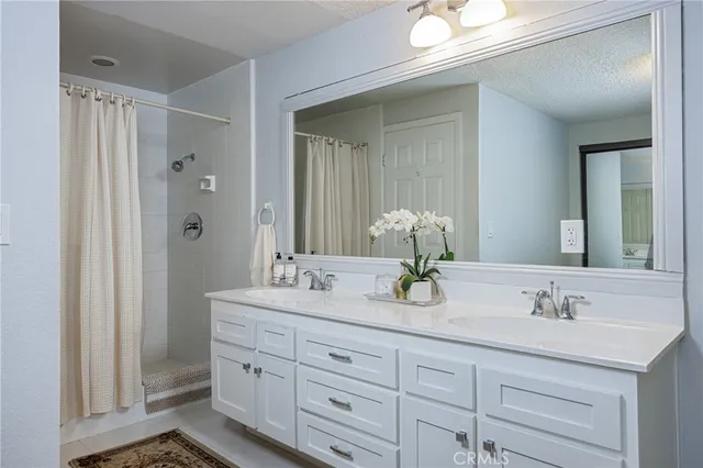 a bathroom with double sink and a mirror
