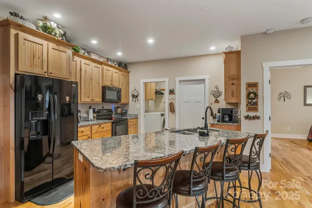 a living room with lots of furniture and kitchen view