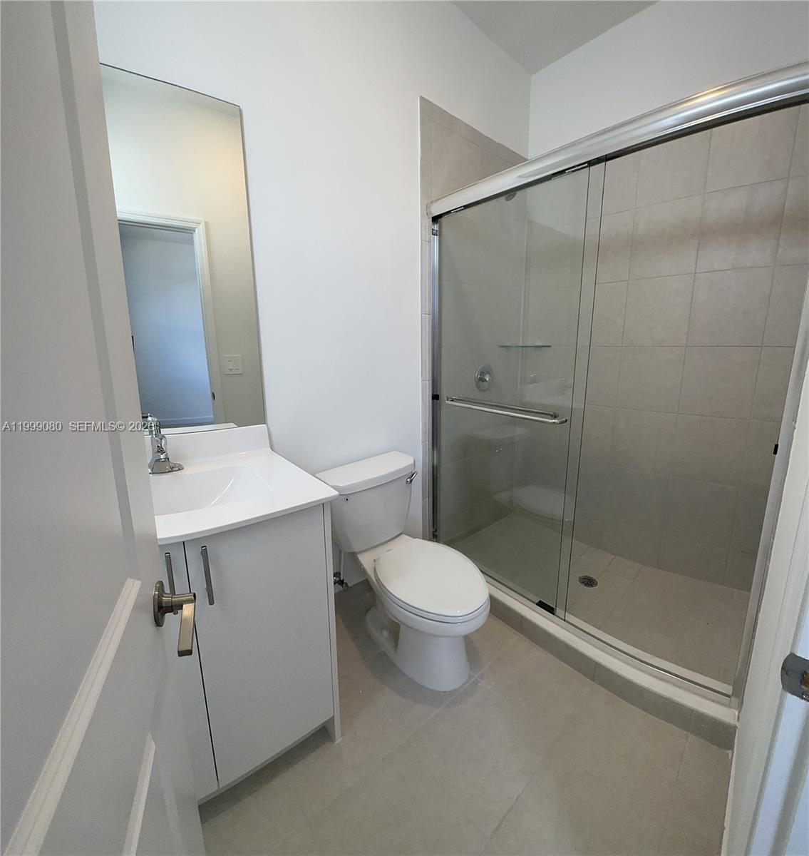 11767 Southwest 246th Terrace Homestead, FL 33032 - Photo 20 of 29 a bathroom with a shower sink vanity and toilet