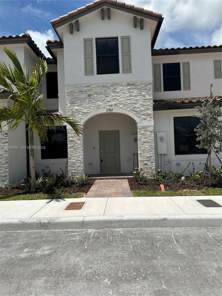 11767 Southwest 246th Terrace Homestead, FL 33032 - Photo 2 of 29 a front view of a house with a yard