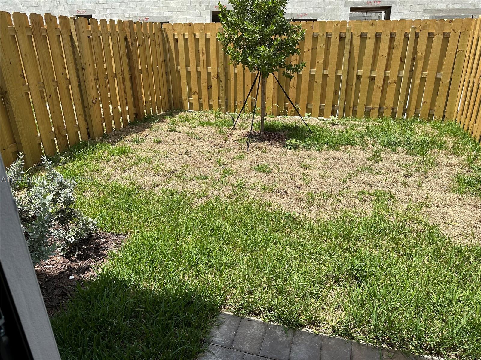 11767 Southwest 246th Terrace Homestead, FL 33032 - Photo 24 of 29 a backyard of a house with grass and plants